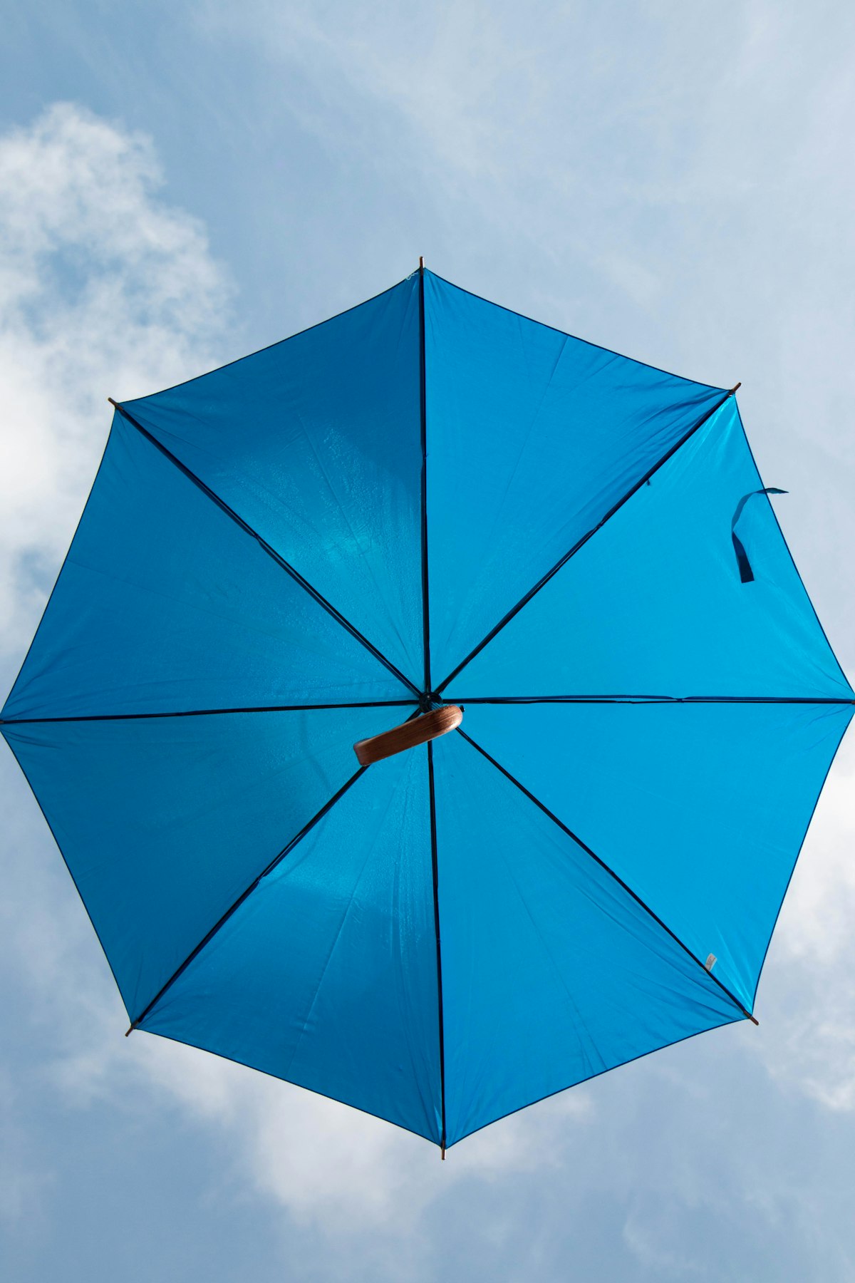 Person holding a clear umbrella representing personal umbrella liability insurance in Wisconsin